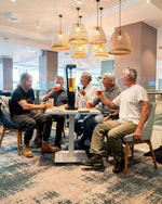 A group of men drinking from a booze tower's beer tower. Australia's number 1 provider of certified beer towers and cocktail towers.r