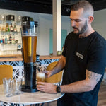  A Man Pouring A Beer From The Booze Tower's Beer Tower. Australia's number 1 provider of certified beer towers and cocktail towers.