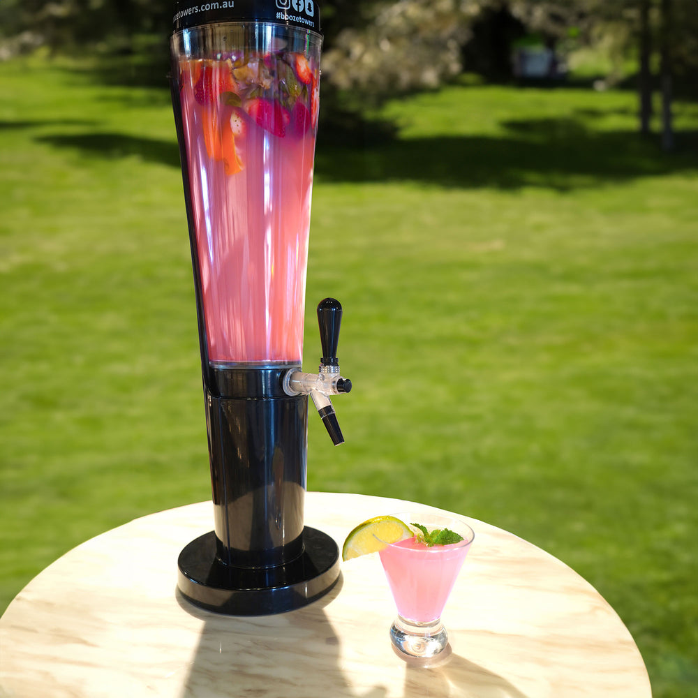 This image shows a booze towers cocktail tower filled with a pink cocktail. Australia's number 1 provider of certified beer towers and cocktail towers.