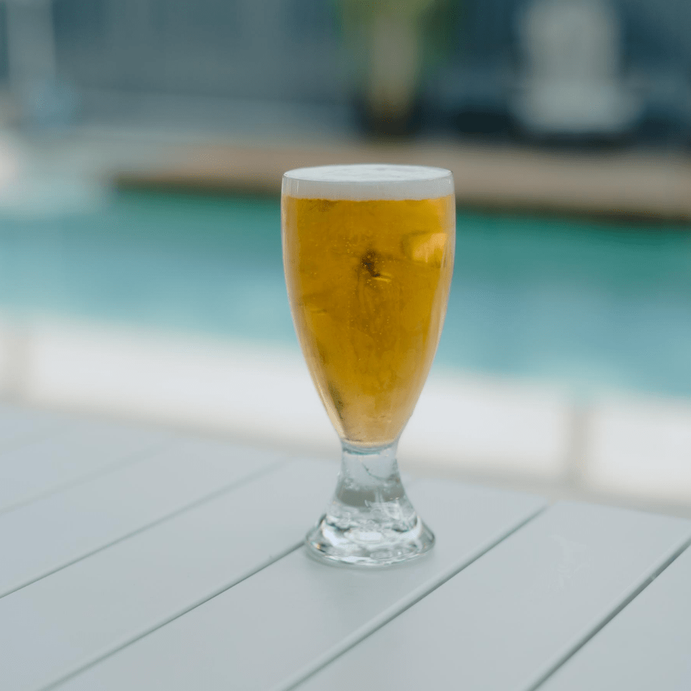 a 425ml Polycarbonate Certified Beer Glass with Bubble Base that has been filled by a booze towers beer tower