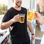 Two people are drinking beers from Polycarbonate 405ml Beer Mugs that have been poured from a booze towers beer tower